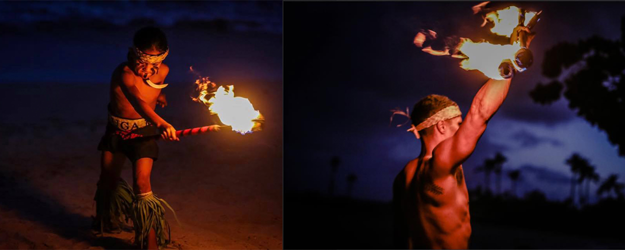 Fire knife dancer spinning flames at night on Oahu